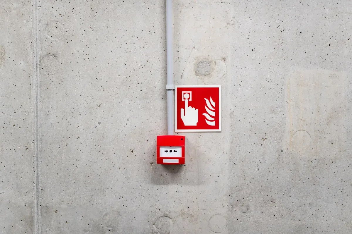 Landlord conducting a fire safety inspection in a Cardiff HMO property